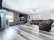 Living room featuring a statement stone wall and modern floors at 1727 Wood Path, Auburndale, FL 33823
