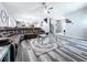 Open-concept living room featuring modern gray floors and ceiling fan at 1727 Wood Path, Auburndale, FL 33823