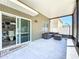 The covered lanai with patio furniture provides a relaxing outdoor space for entertaining and dining at 1727 Wood Path, Auburndale, FL 33823