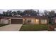 Charming single-story home with a well-manicured lawn, brick accents, and a spacious two-car garage at 1859 Lake Hill Cir, Orlando, FL 32818