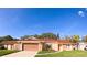 Charming single-story home with a spacious garage, well-manicured lawn, and beautiful landscaping at 1859 Lake Hill Cir, Orlando, FL 32818
