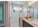 Modern bathroom featuring glass-enclosed shower and sleek vanity with fresh flower accents at 244 Villa Domani Cir, Davenport, FL 33896