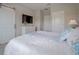 Serene bedroom with sliding barn door, dresser with a TV, and a bright, airy feel at 244 Villa Domani Cir, Davenport, FL 33896