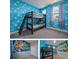 The bedroom features a playful theme, bunk beds, and a window providing natural light at 244 Villa Domani Cir, Davenport, FL 33896