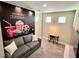 Cozy bonus room decorated with movie theme mural and a comfortable gray sofa at 244 Villa Domani Cir, Davenport, FL 33896
