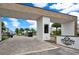 Community entrance with decorative brickwork, gate, and lush landscaping at 244 Villa Domani Cir, Davenport, FL 33896