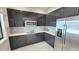 Sleek, modern kitchen with stainless steel appliances and gray cabinetry at 244 Villa Domani Cir, Davenport, FL 33896