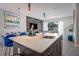 Open-concept kitchen featuring a quartz island, modern lighting, and seamless flow to living area at 244 Villa Domani Cir, Davenport, FL 33896