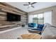 Contemporary living room with accent wall, plush seating, and sliding glass doors to the pool at 244 Villa Domani Cir, Davenport, FL 33896