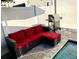 Cozy outdoor patio with red cushioned seating and a grill, perfect for entertaining near the pool at 244 Villa Domani Cir, Davenport, FL 33896
