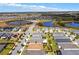Aerial view of the neighborhood featuring beautiful homes and scenic lakes at 440 Alcove Dr, Groveland, FL 34736