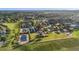 Scenic aerial view of tennis courts surrounded by lush greenery in a vibrant community, offering a healthy lifestyle at 440 Alcove Dr, Groveland, FL 34736