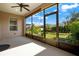 Relaxing back porch with ceiling fan and view of the manicured lawn at 440 Alcove Dr, Groveland, FL 34736