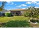 Lovely backyard with lush green grass, mature trees and well-maintained landscaping at 440 Alcove Dr, Groveland, FL 34736