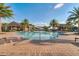 Community pool with ample seating surrounded by lush landscaping, under a bright, sunny sky at 440 Alcove Dr, Groveland, FL 34736