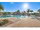 Beautiful community pool with blue skies, palm trees and nice landscaping at 440 Alcove Dr, Groveland, FL 34736