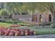 Landscaped entrance to the Trilogy community with vibrant foliage at 440 Alcove Dr, Groveland, FL 34736