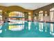 Indoor pool area with tall windows, decorative accents, and lane markers for recreational swimming at 440 Alcove Dr, Groveland, FL 34736