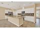 Spacious kitchen featuring a granite island, stainless steel appliances, pendant lighting and ample cabinetry at 440 Alcove Dr, Groveland, FL 34736