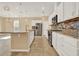 A well-equipped kitchen with granite countertops, stainless steel appliances, and ample cabinet space at 440 Alcove Dr, Groveland, FL 34736