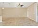 A spacious living room with neutral paint, tile floors, and a ceiling fan at 440 Alcove Dr, Groveland, FL 34736