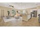 Bright, open-plan living space featuring stylish furnishings and a modern kitchen with stainless steel appliances at 440 Alcove Dr, Groveland, FL 34736