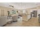 Bright, open-plan living space featuring stylish furnishings and a modern kitchen with stainless steel appliances at 440 Alcove Dr, Groveland, FL 34736