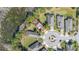Aerial view of the home in a cul-de-sac with lake views, surrounded by lush landscaping and trees at 513 San Sebastian Ct, Davenport, FL 33837
