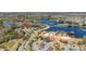 Aerial view of neighborhood amenities including a large pool, clubhouse, lake, and scenic landscaping at 513 San Sebastian Ct, Davenport, FL 33837