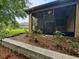 Backyard featuring screened-in porch, mulch beds, small shrubs, and a privacy wall at 513 San Sebastian Ct, Davenport, FL 33837