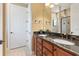 Bathroom with double sink vanity, granite countertop, tile floors, and a glass-enclosed shower at 513 San Sebastian Ct, Davenport, FL 33837
