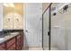 Bathroom featuring a glass-enclosed shower, tile floors, and a double sink vanity with a dark countertop at 513 San Sebastian Ct, Davenport, FL 33837