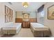 Inviting bedroom with two twin beds, rustic furniture, and playful decor accents at 513 San Sebastian Ct, Davenport, FL 33837