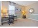 Bright bedroom featuring a modern wooden desk, neutral carpet, and decorative wall accents at 513 San Sebastian Ct, Davenport, FL 33837