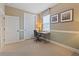 Cozy room featuring a desk and chair setup by the window and a closet with painted accents at 513 San Sebastian Ct, Davenport, FL 33837