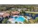 Aerial view of the community pool area, featuring a pool, spa, and seating at 513 San Sebastian Ct, Davenport, FL 33837