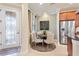 Cozy dining area with a round table, stylish chairs, and a view of the lush landscaping at 513 San Sebastian Ct, Davenport, FL 33837