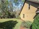 Side view of a stucco home featuring well-maintained lawn and neatly arranged landscaping at 513 San Sebastian Ct, Davenport, FL 33837