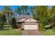 Charming single-Gathering home with a two-car garage, paver driveway, and manicured landscaping at 513 San Sebastian Ct, Davenport, FL 33837