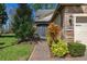 Home's entrance with brick pathway, manicured landscaping, stone accents, and a secure front door at 513 San Sebastian Ct, Davenport, FL 33837