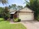 Charming home with a stone facade and a well-manicured lawn with mature landscaping at 513 San Sebastian Ct, Davenport, FL 33837