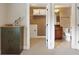 Hallway showcasing a closet and adjacent bathroom with decorative accents at 513 San Sebastian Ct, Davenport, FL 33837