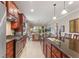 Well-equipped kitchen showcases stainless steel appliances, granite countertops, and seamless flow to the dining area at 513 San Sebastian Ct, Davenport, FL 33837