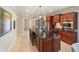 Bright kitchen featuring a large island with seating, stainless appliances, and ample counter space at 513 San Sebastian Ct, Davenport, FL 33837