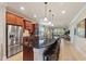 Open kitchen featuring stainless steel appliances, a granite island, and seamless flow to the living area at 513 San Sebastian Ct, Davenport, FL 33837