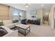 Bright living room with a comfortable seating area and natural light streaming through large windows at 513 San Sebastian Ct, Davenport, FL 33837
