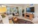 Bright and airy living room featuring comfortable seating and large windows overlooking the landscape at 513 San Sebastian Ct, Davenport, FL 33837