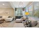 Bright living room with a large sectional sofa, a decorative ceiling light and view of the backyard at 513 San Sebastian Ct, Davenport, FL 33837