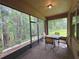 Screened-in porch featuring brick flooring and a table with chairs overlooking a private backyard at 513 San Sebastian Ct, Davenport, FL 33837