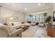 Cozy sitting area with neutral tones, large windows, and stylish accents, perfect for relaxation at 513 San Sebastian Ct, Davenport, FL 33837